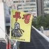 -7월 14일 오후 민주노총과 한국노총 소속의 톨게이트 요금수납 노동자 40여 명이 집단해고 철회와 직접고용을 요구하며 15일 째 서울 톨게이트 지붕 위에서 고공농성을 하고 있다. 