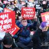 -2월 11일 오후 서울 시청역 인근 세종대로에서 열린 윤석열 퇴진 집회에서 참가자들이 팻말을 들고 구호을 외치고 있다.